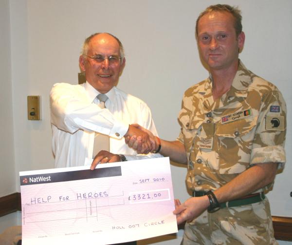 President Malcolm Bellamy presenting cheque to Sergeant Dan Allinson. pic:BerbardSwift
